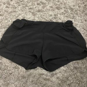 Black Lululemon speed up shorts.